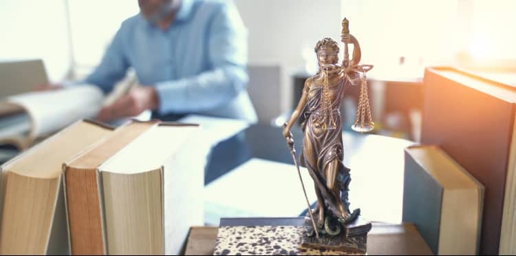 Lady Justice Statue On Truck Accident Injury Lawyers Desk