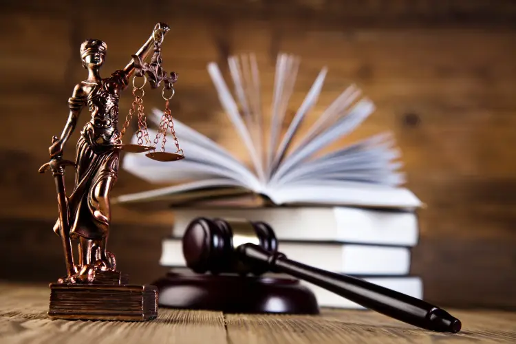 Lady Justice Statue With Personal Injury Law Books And Gavel