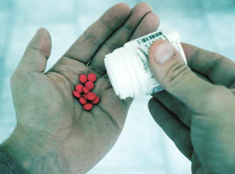 Pills in man's hand