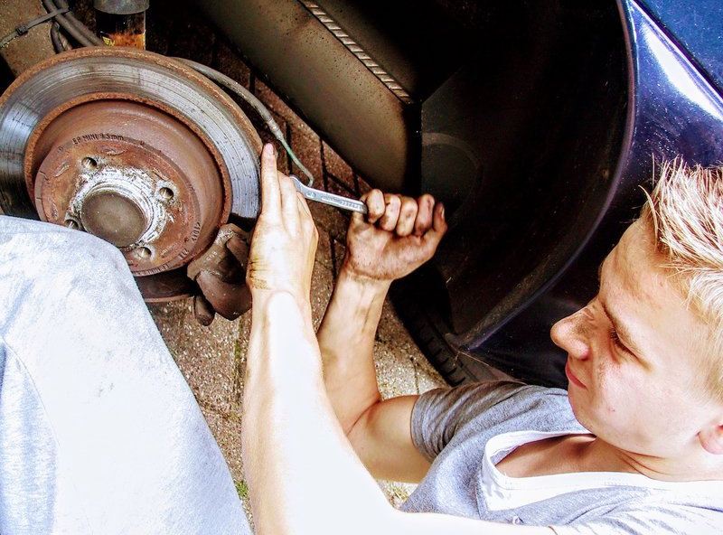Young Man Repairing Car